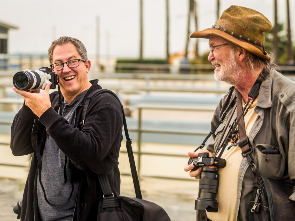 Paul Gero and Chuck Jones with Sony cameras near the entrance to the Seal Beach pier.   Image Credit: Jim Quinn.